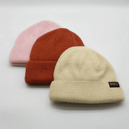 Three beanies in pink, red and beige colors